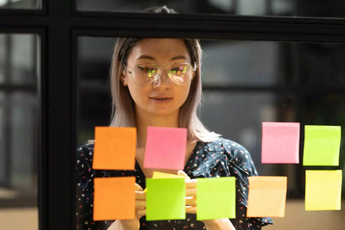 Employee using sticky notes to create brand tagline