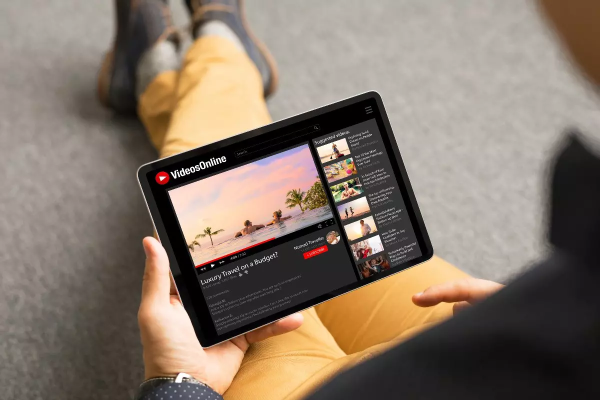 Close up on individual watching YouTube video on tablet